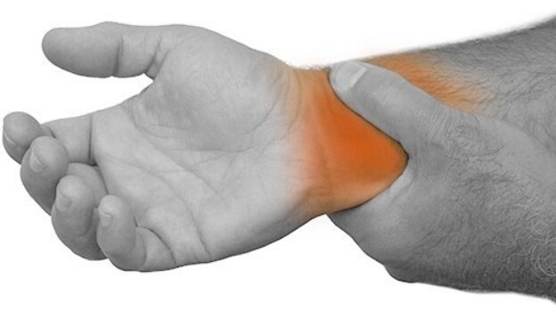 Et illustrasjonbilde av en hånd som holder den andre hånden i grått, med smerter i håndledd som lyser opp i orange, med hvit bakgrunn